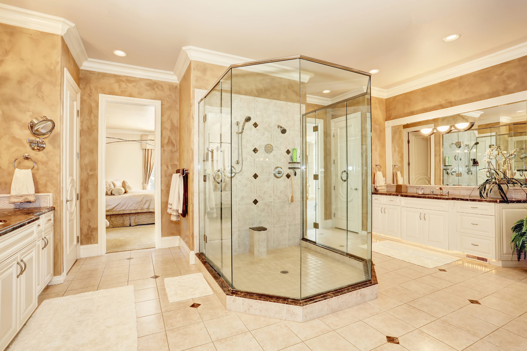 Beautiful luxury marble bathroom interior in beige color. Large glass walk in shower and two vanity cabinets. Northwest, USA